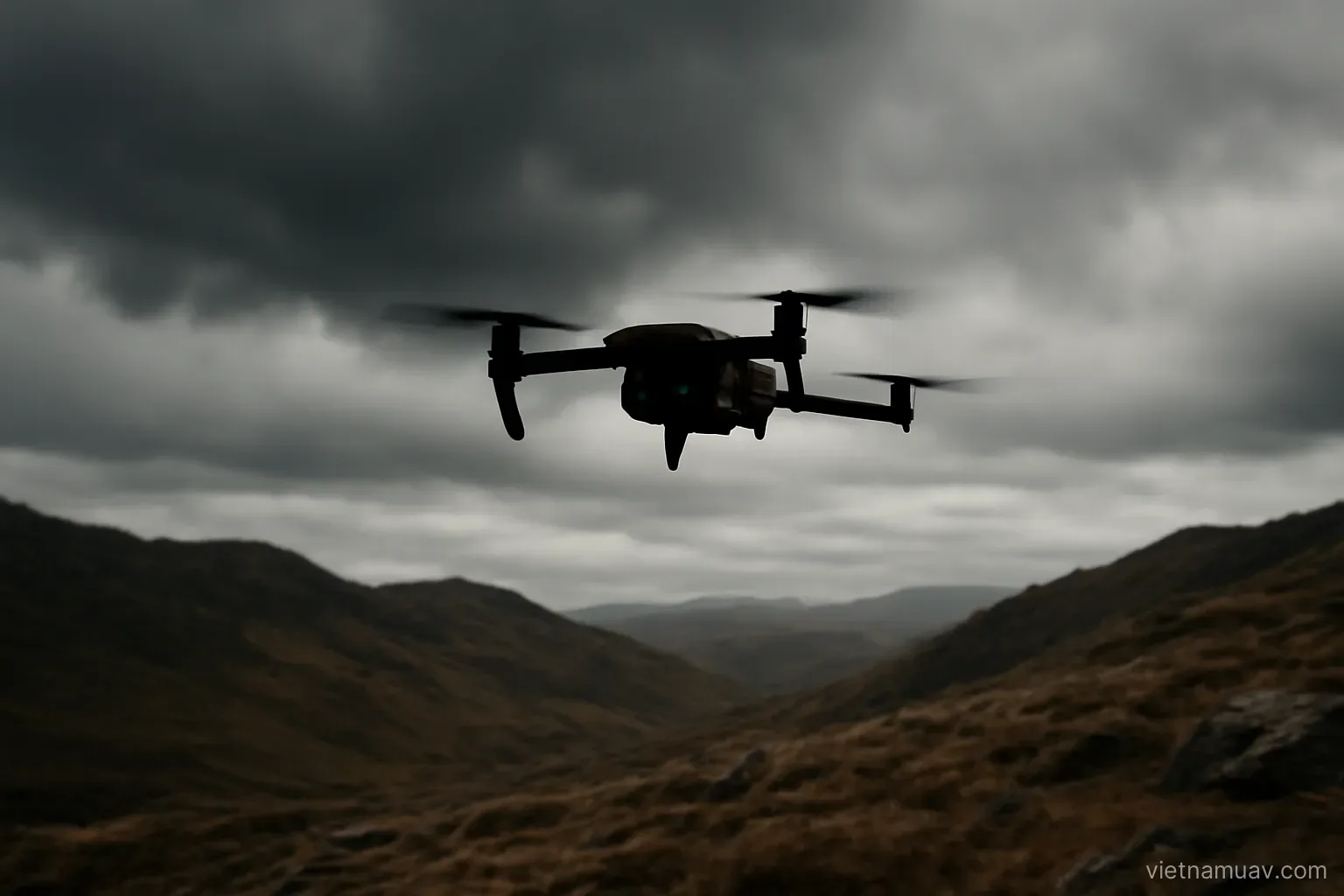 Drone flying under overcast sky over rugged ground