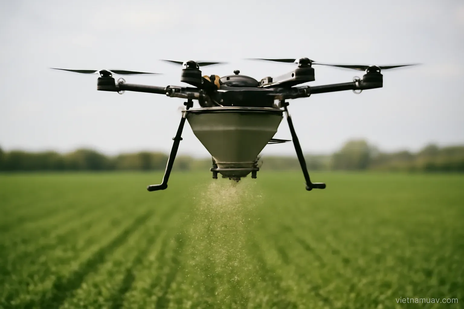 Drone with a spreader hopper over a field